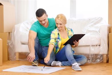 happy couple checking their checklist for moving home