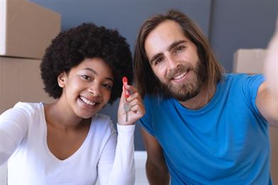 happy couple moving house during a global pandemic